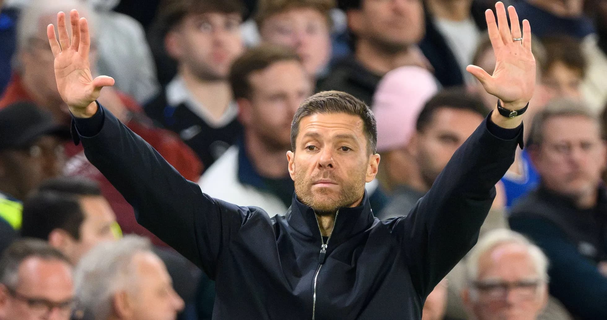 Coach gesturing during a football match from the sideline