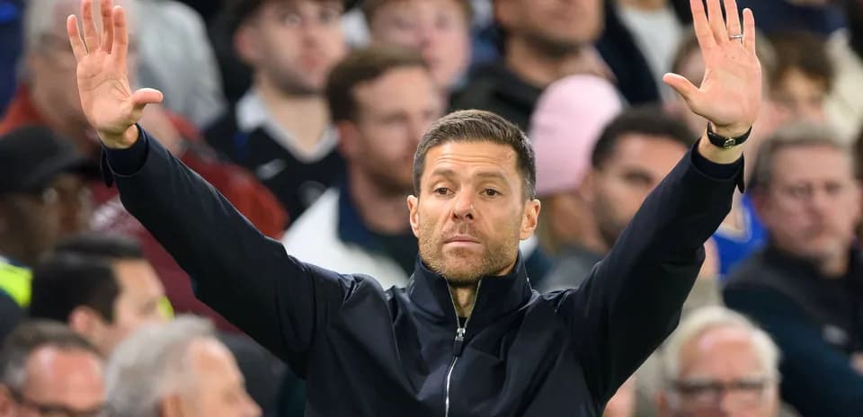 Coach gesturing during a football match from the sideline