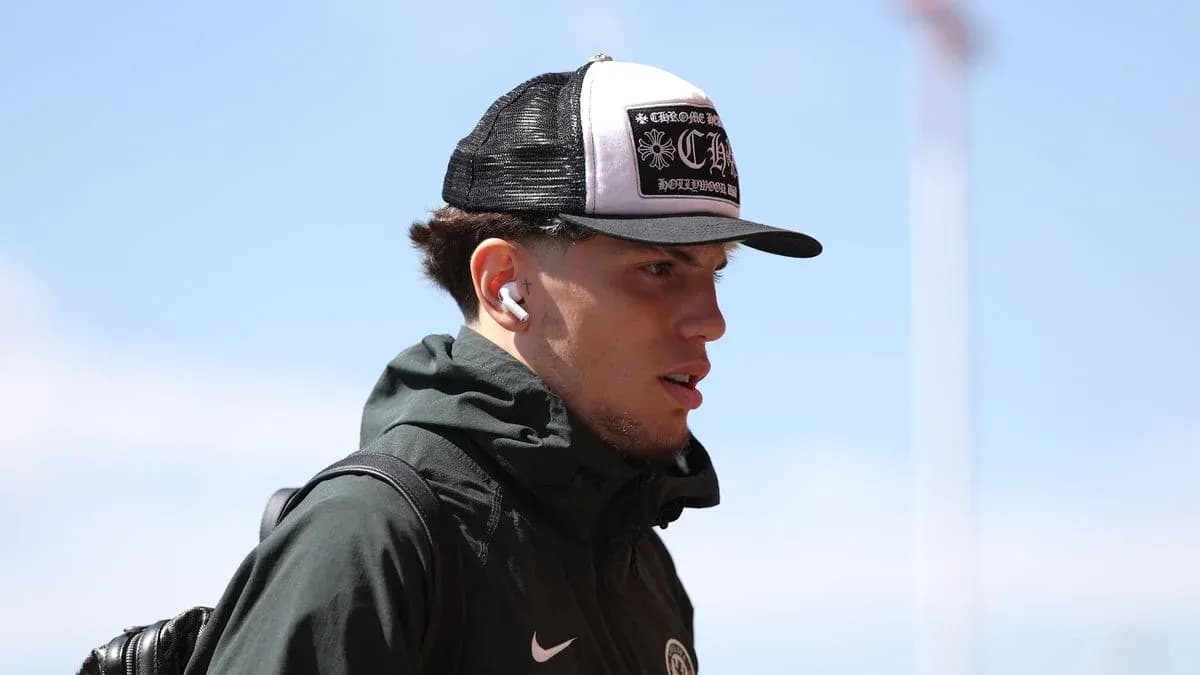 Player wearing a hat and earbuds walking outdoors