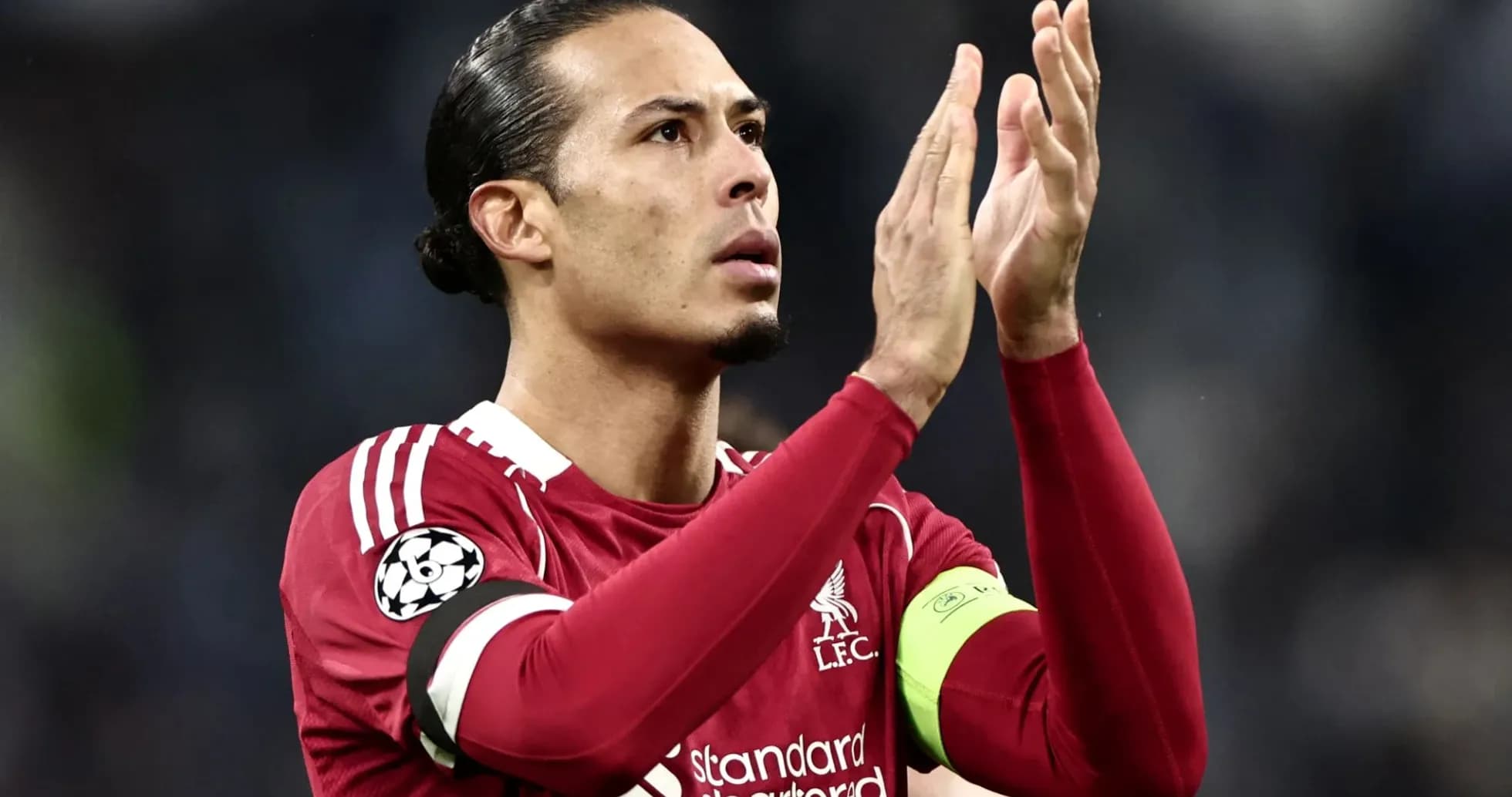 Player applauding fans wearing Liverpool kit