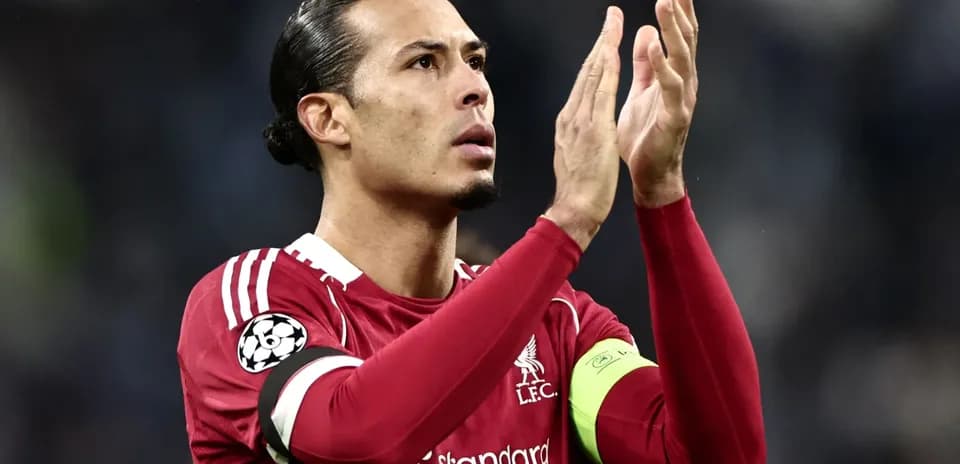 Player applauding fans wearing Liverpool kit