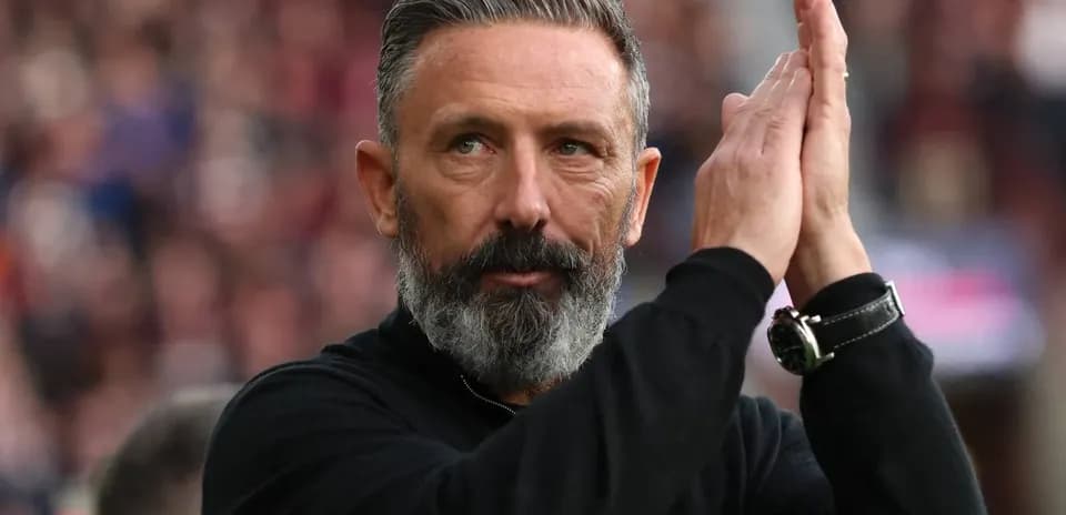 Manager applauding fans during a match