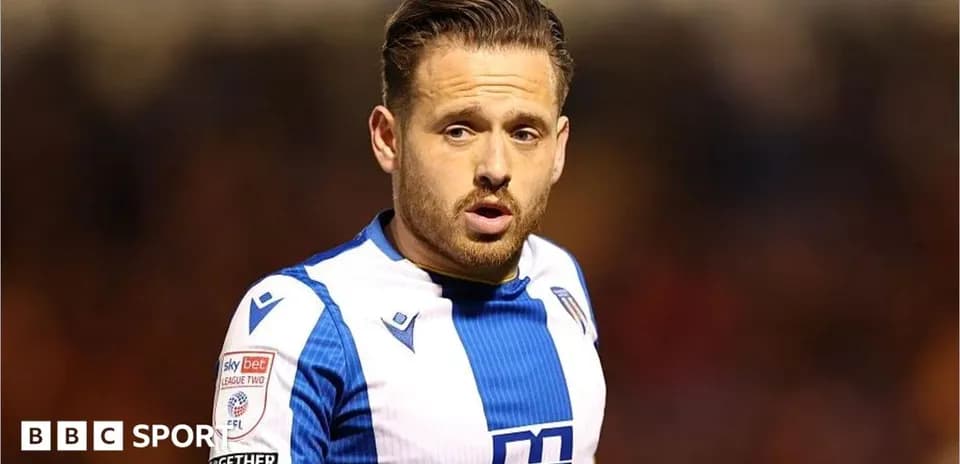 Player wearing blue and white kit on field