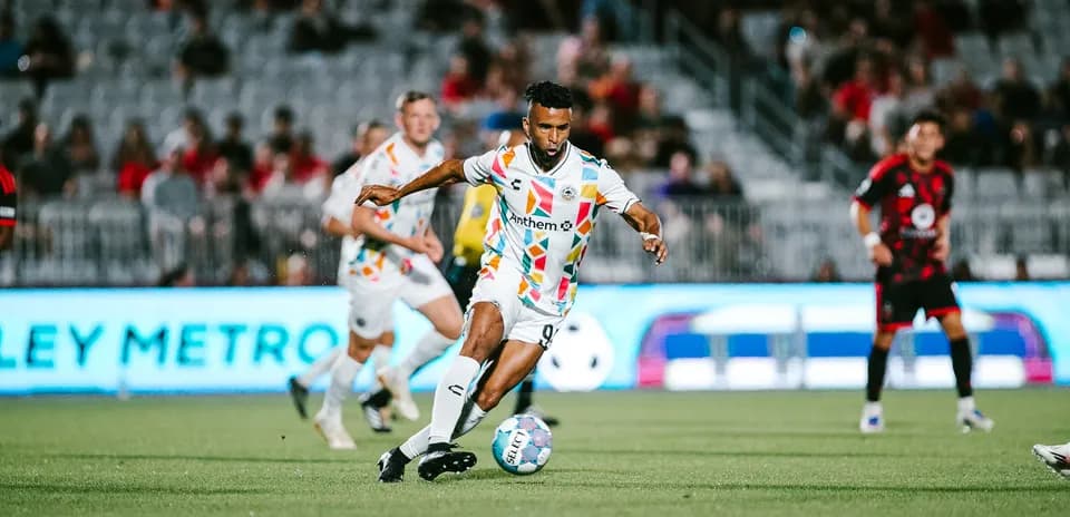 Player dribbling during Phoenix Rising match