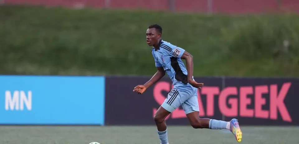 Player running with ball during Minnesota match