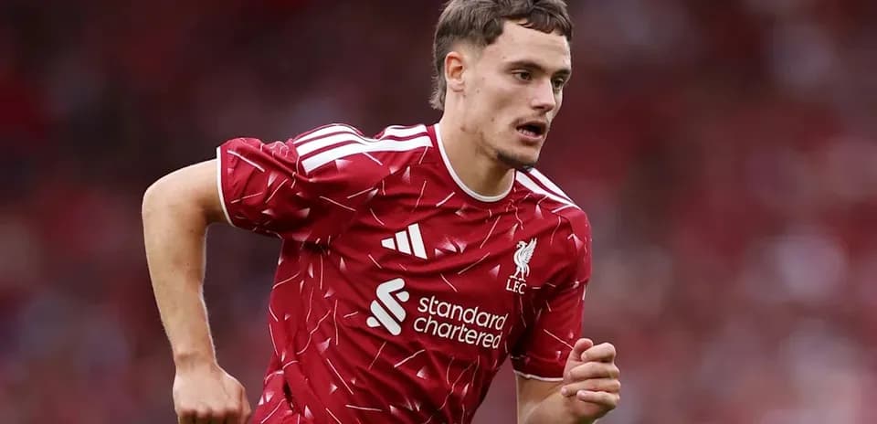 Player running in Liverpool kit during match