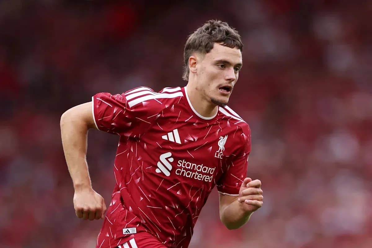 Player running in Liverpool kit during match