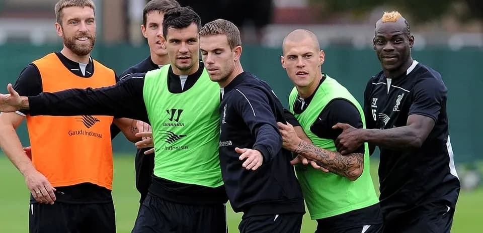 Liverpool players training in green and orange vests