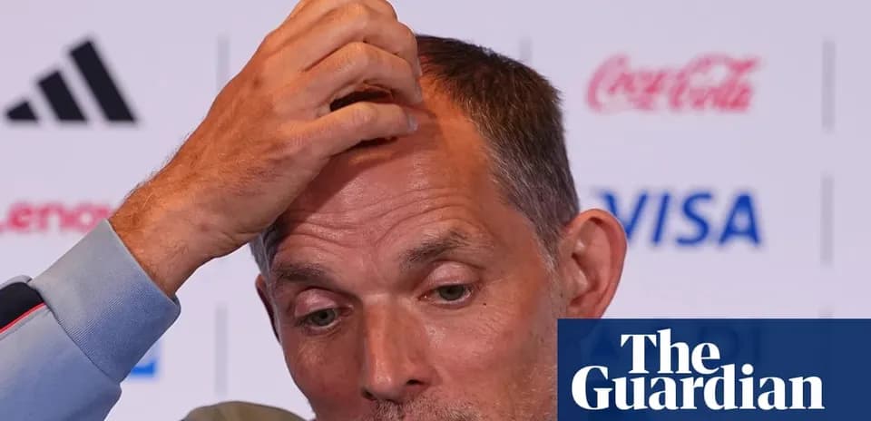 Manager speaking at press conference, hand on head