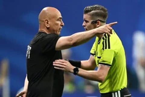 Referee discussing with coach during match