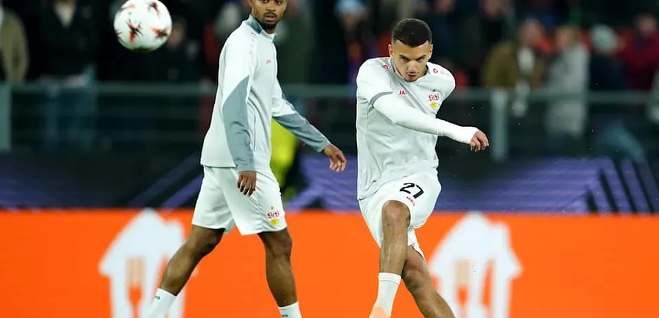 Player kicking ball during warm-up session on pitch