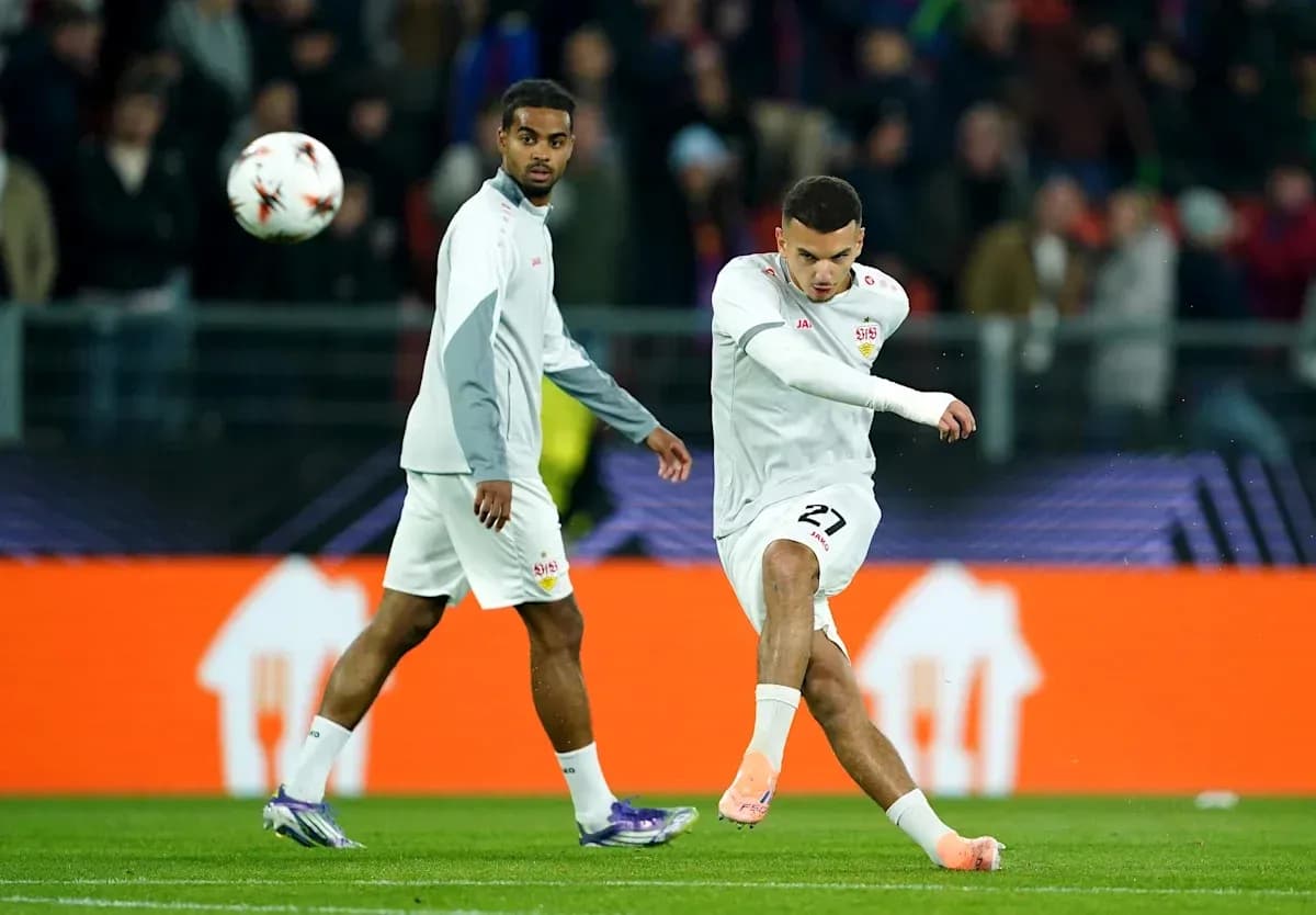 Player kicking ball during warm-up session on pitch