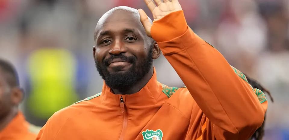 Player waving while wearing Cote d'Ivoire training jacket