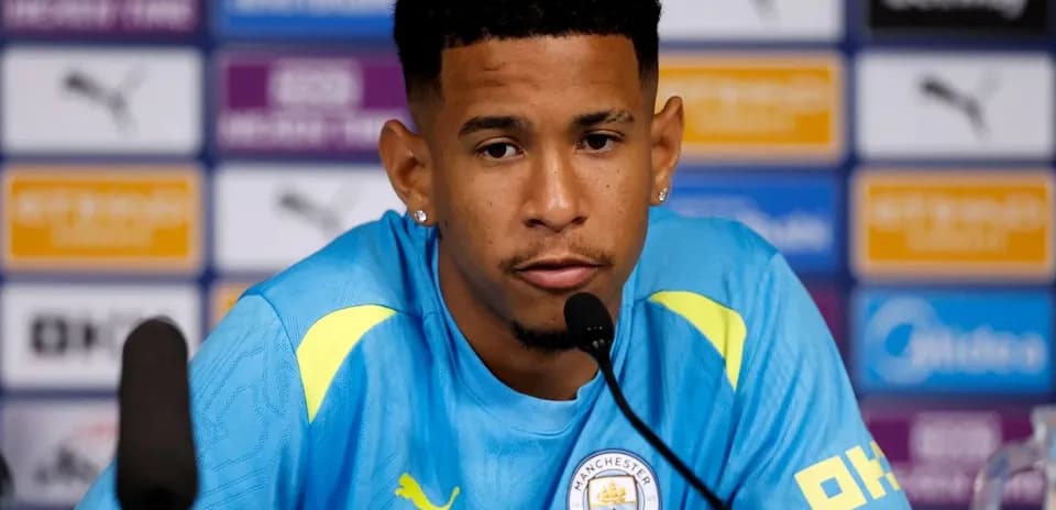 Player speaking at press conference with microphone
