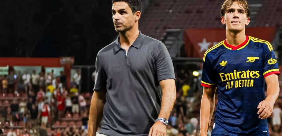 Coach and player walking off the pitch