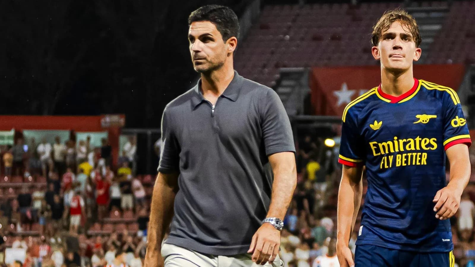 Coach and player walking off the pitch