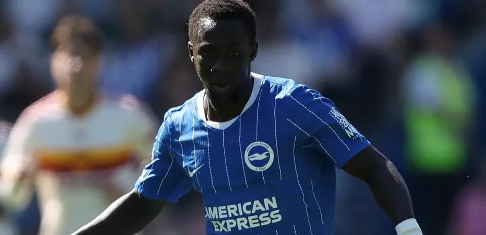 Player in blue kit dribbling the ball on field