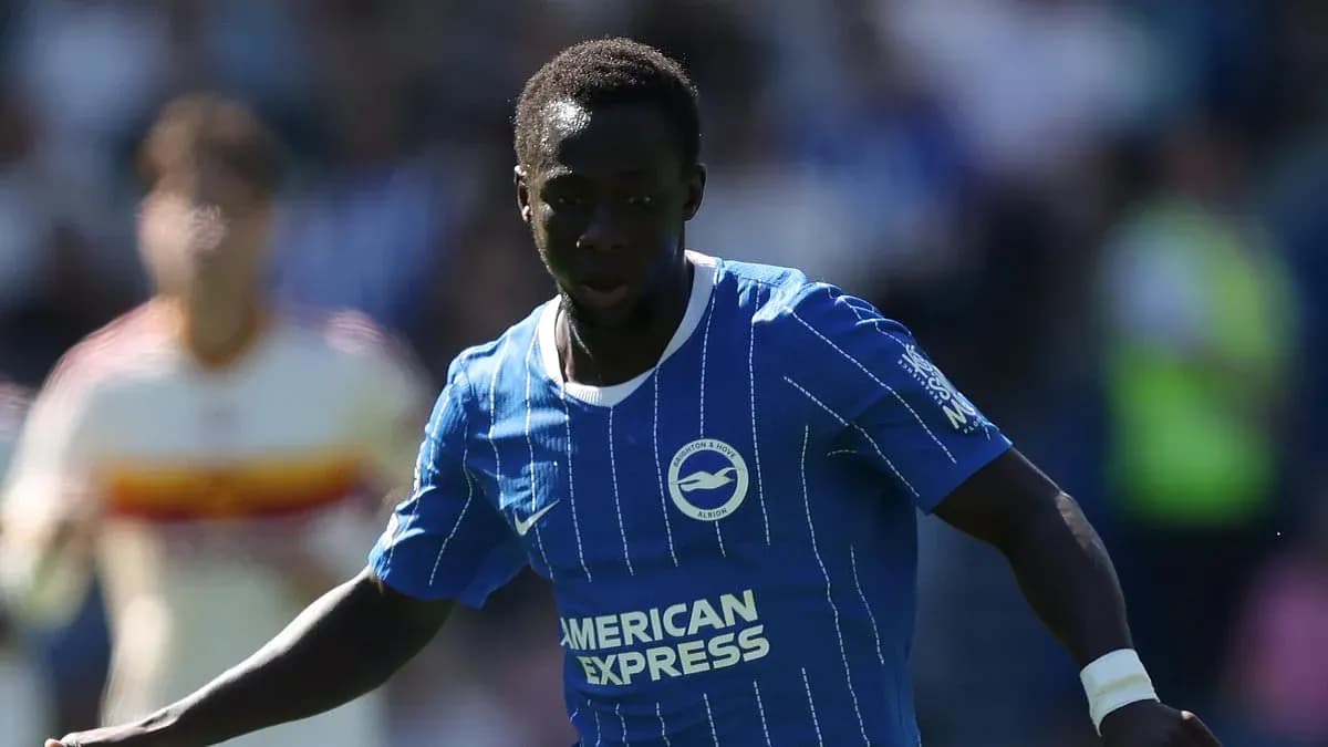 Player in blue kit dribbling the ball on field