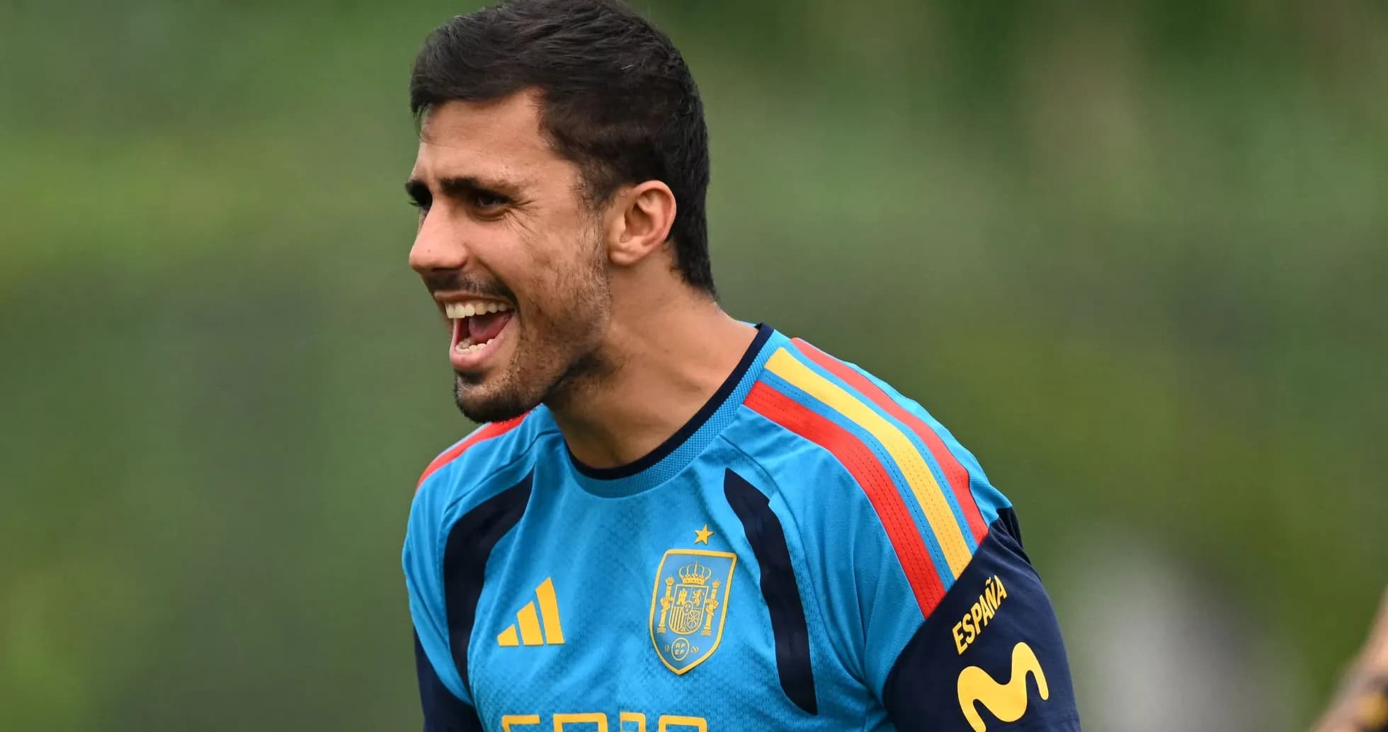 Player training in Spain kit, shouting during practice