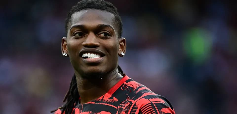 Player smiling in a red patterned jersey