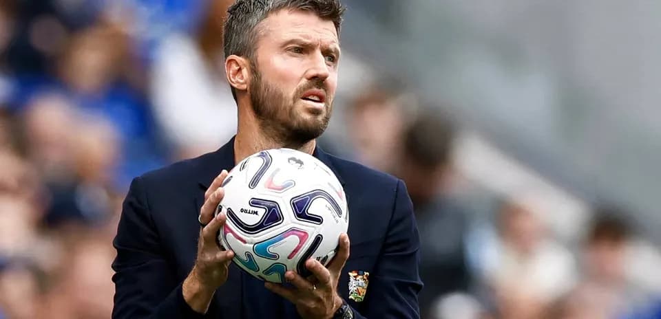 Coach holding ball during match on sideline