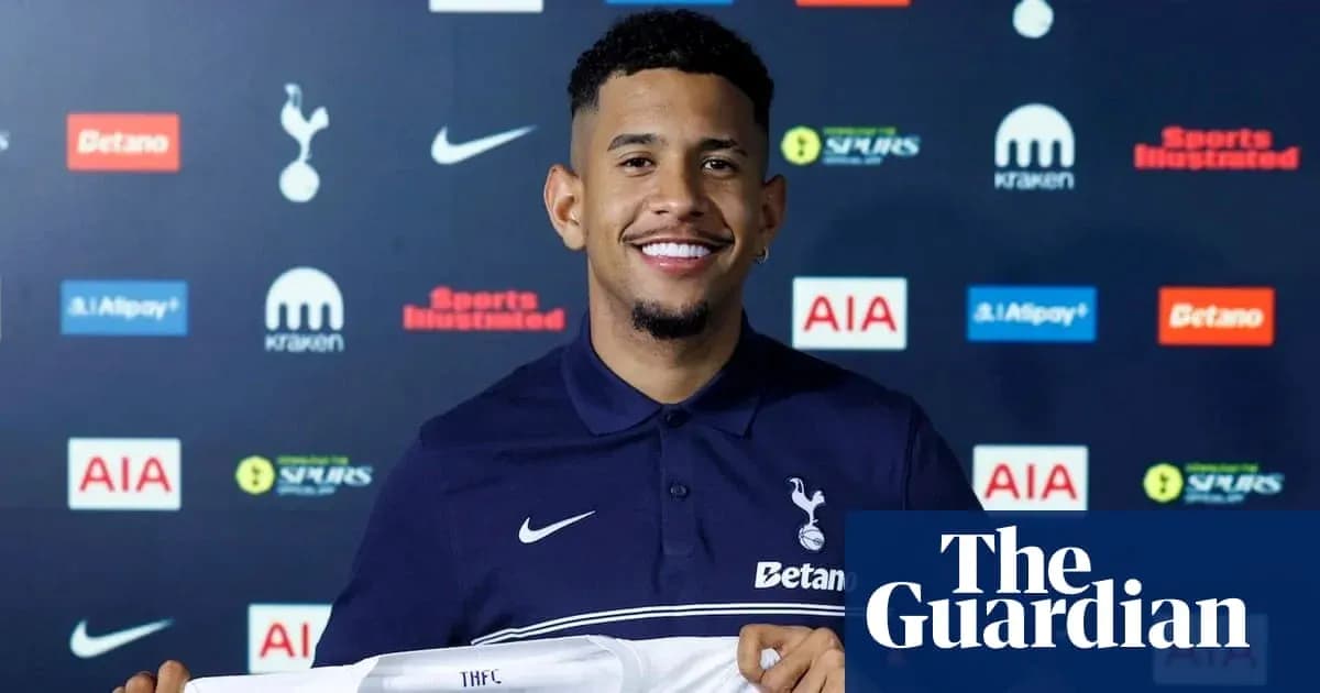Player holding Tottenham Hotspur jersey at announcement