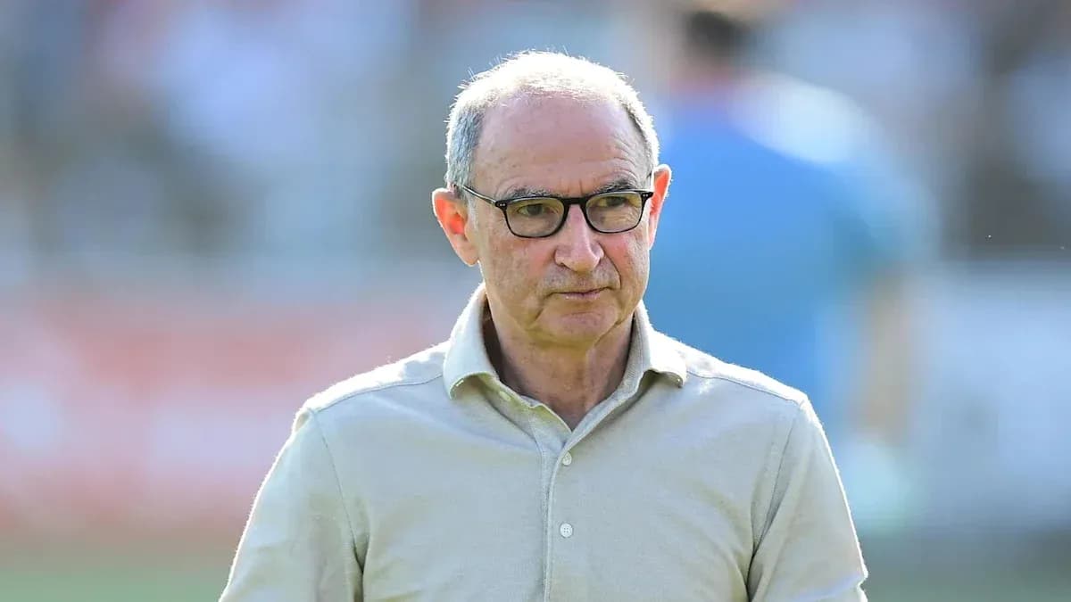 Coach walking on the pitch during a match
