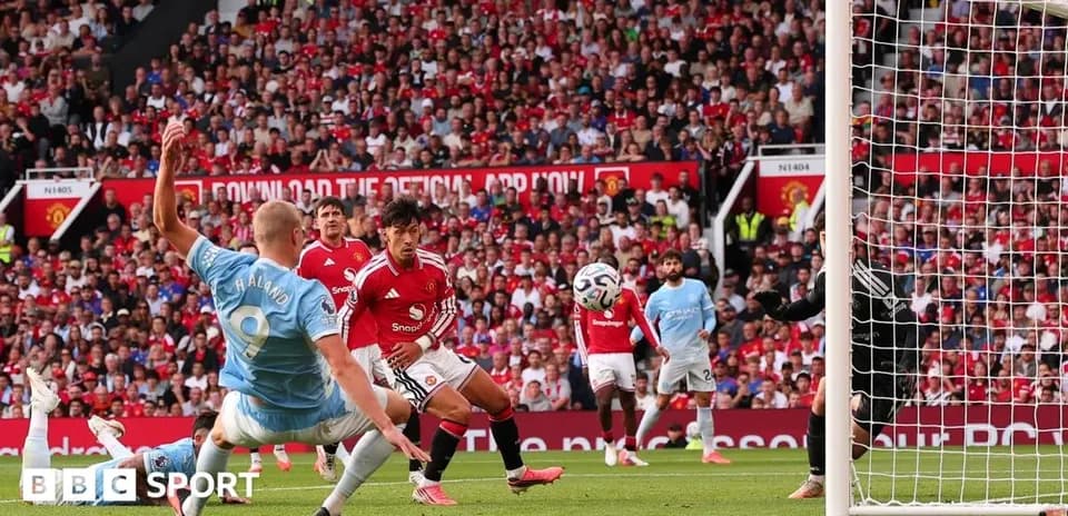 Player striking ball in Manchester derby match