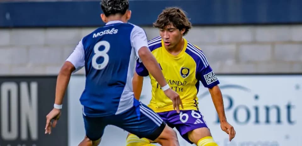 Two players competing for the ball in match