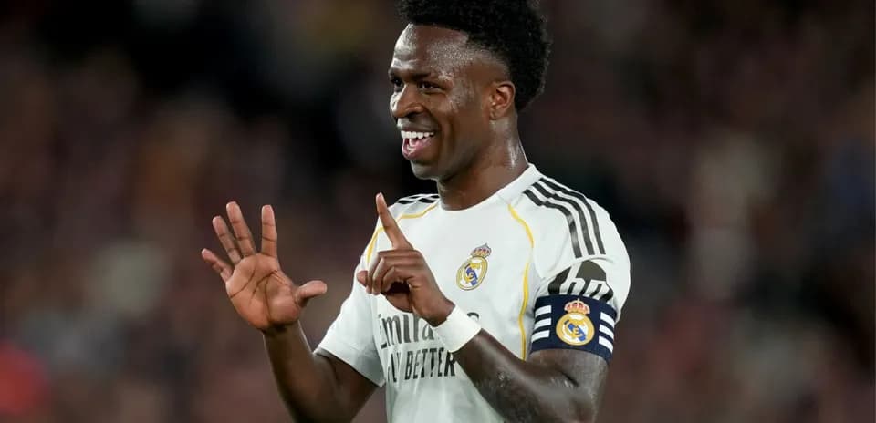 Player celebrating with fingers raised on pitch