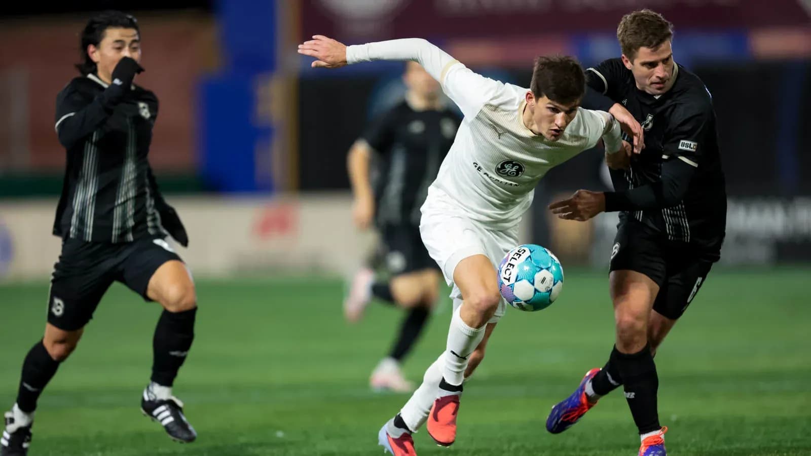 Players competing for the ball in USL Championship