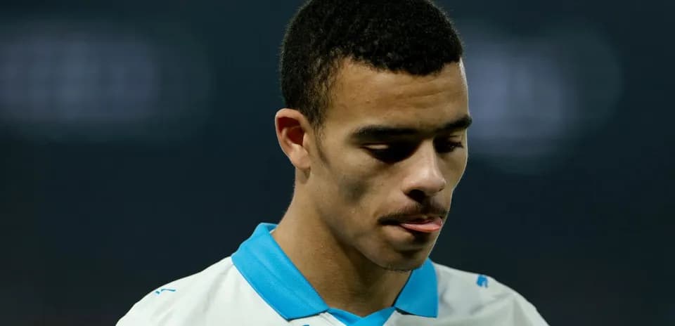 Player in white jersey looking down during match