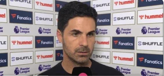 Manager speaking at post-match interview backdrop