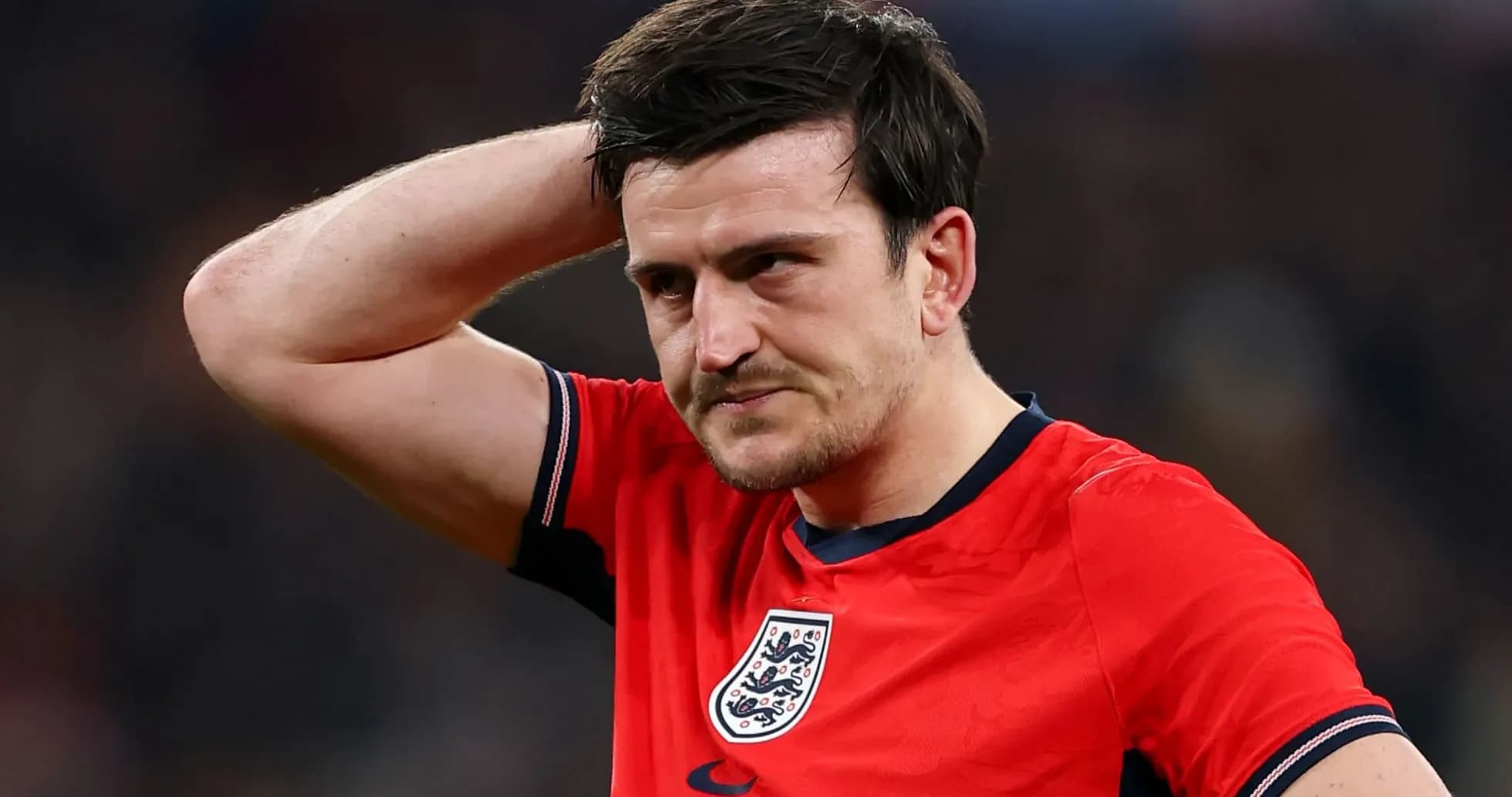 Player in red jersey looks concerned during match