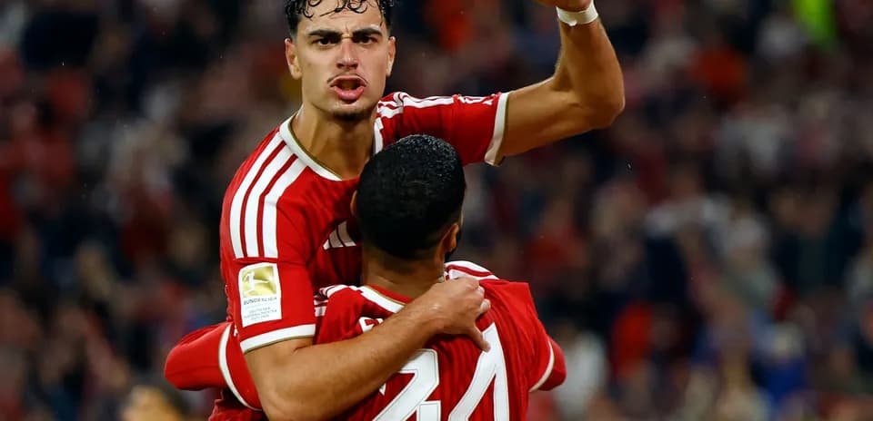 Player celebrating goal with teammate on the pitch