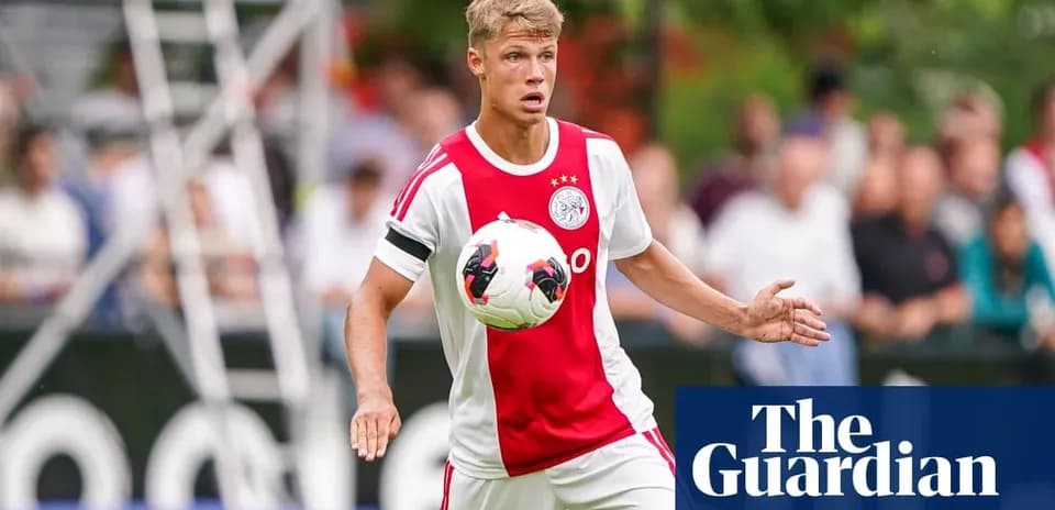 Player in Ajax kit controlling a soccer ball