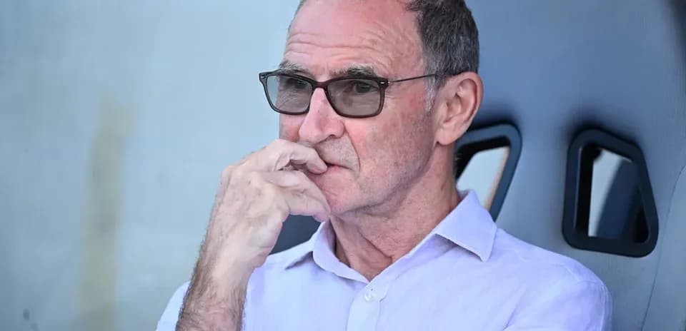 Man in glasses seated on bench during match