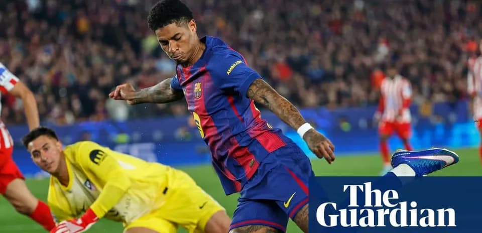 Barcelona player shooting at goal with goalkeeper nearby