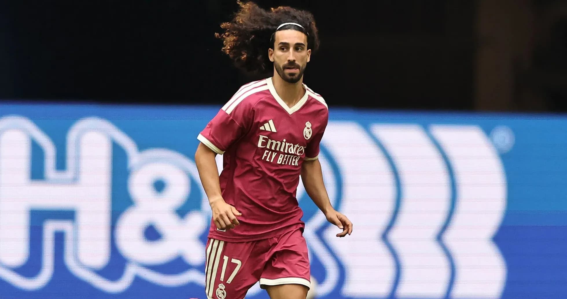 Player running on the field in pink jersey