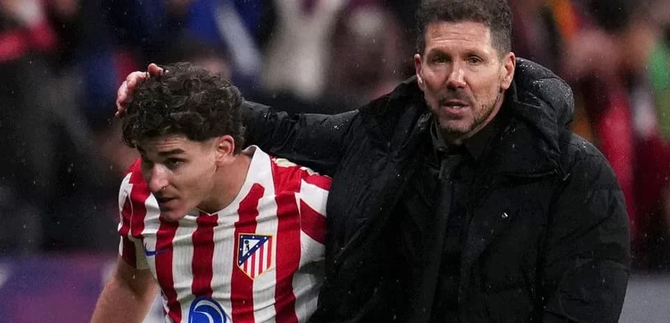 Atletico Madrid coach assisting injured player off field