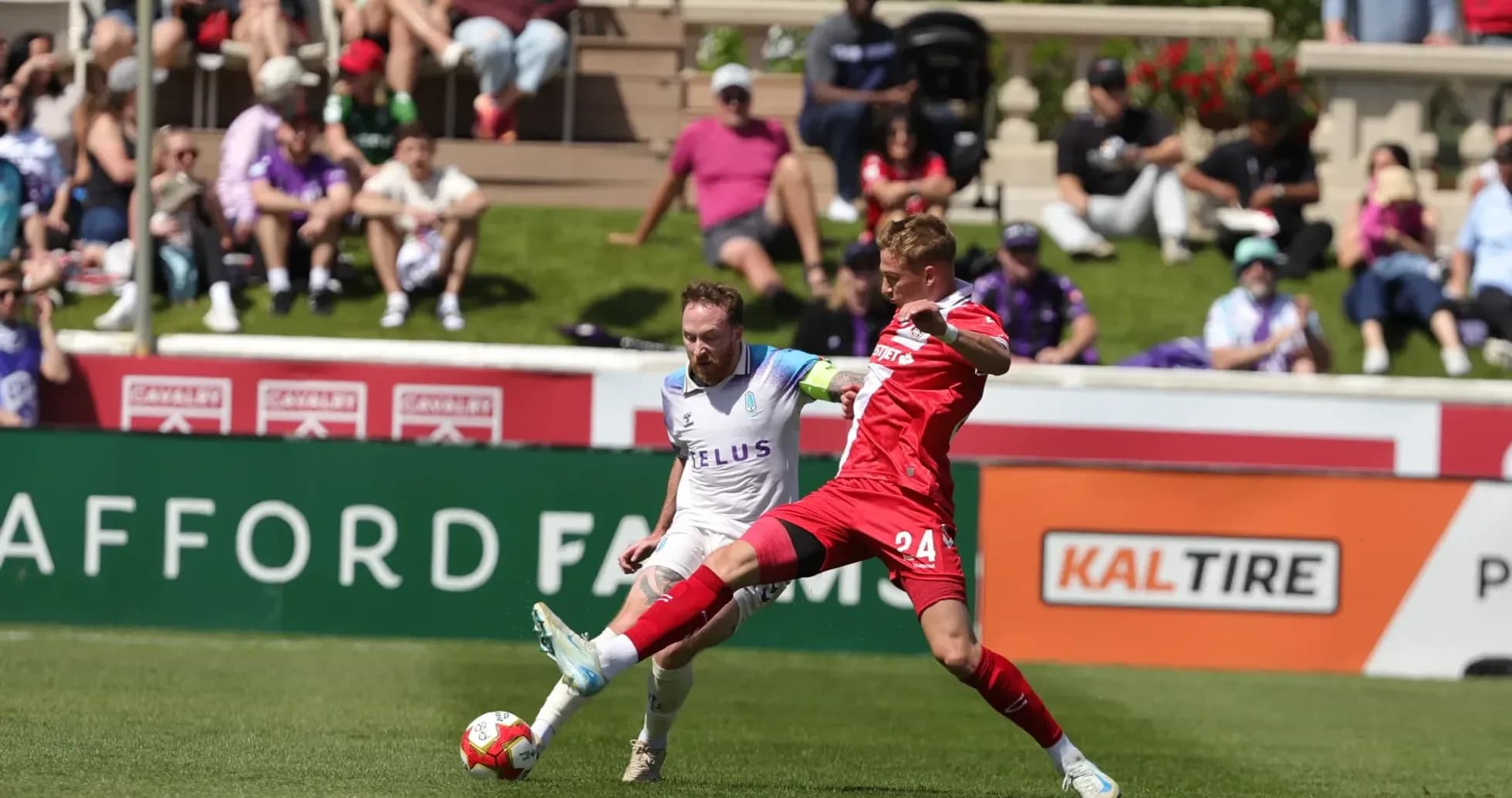 Player tackling opponent during Pacific FC match