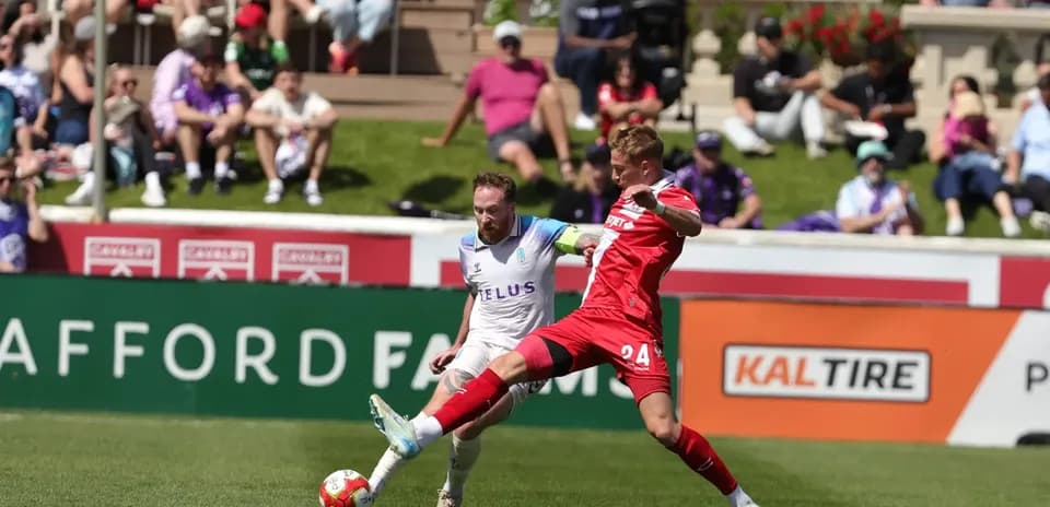 Player tackling opponent during Pacific FC match