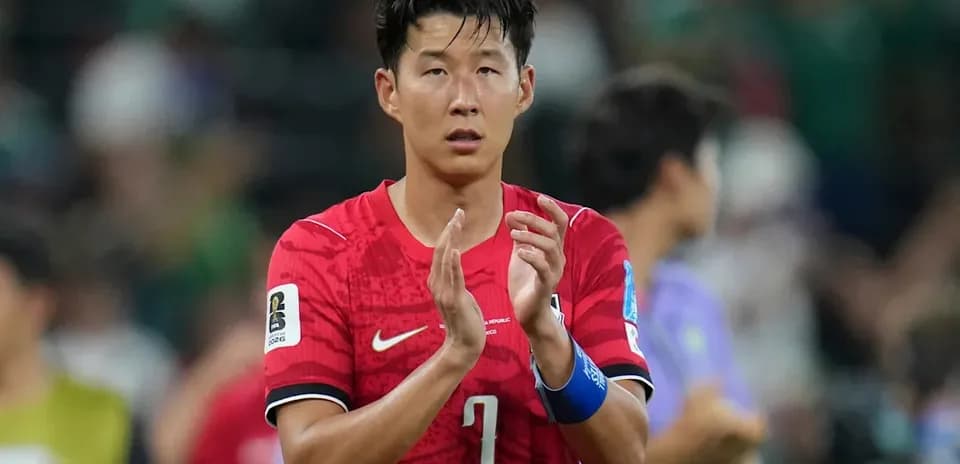 Player in red jersey applauding after match