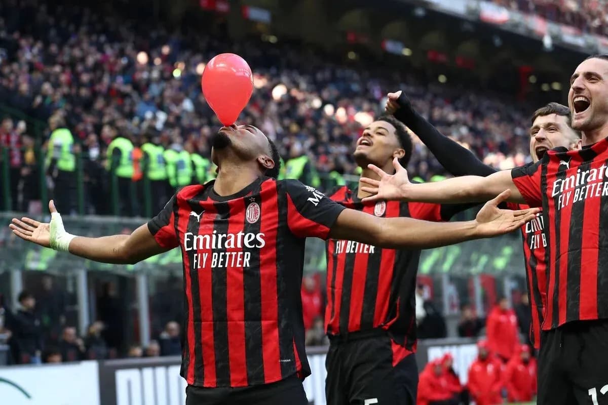 AC Milan players celebrating with a balloon