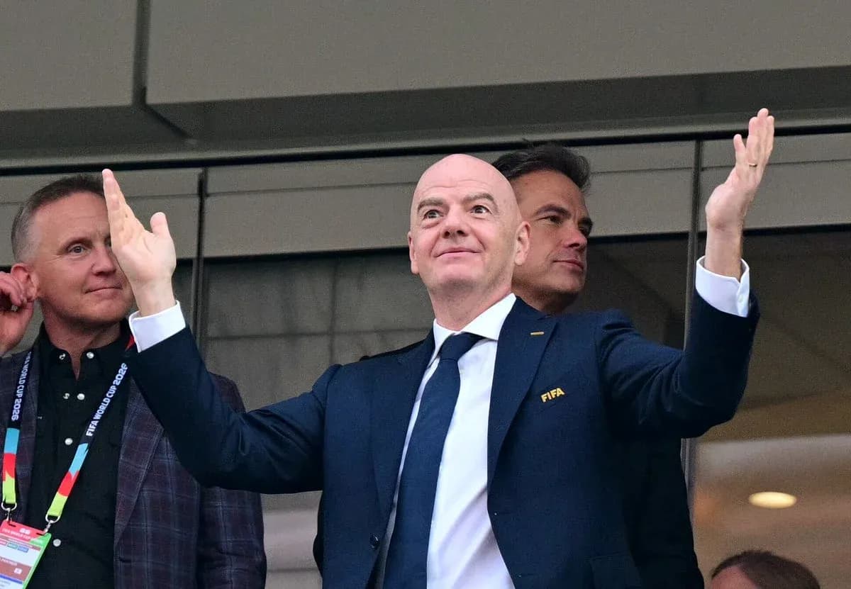 FIFA official gesturing from a VIP box