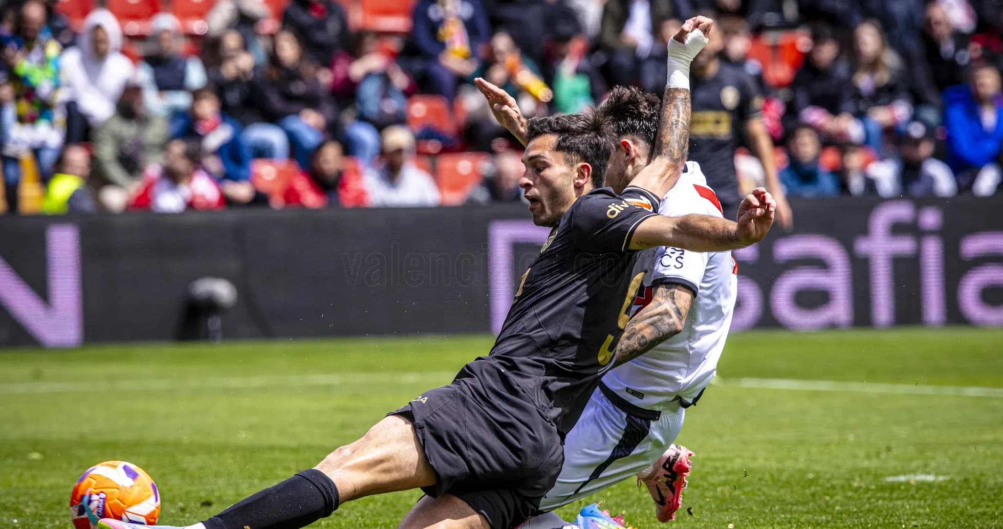 Two players contesting for the ball during match