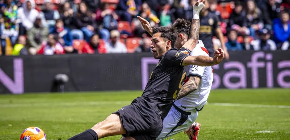 Two players contesting for the ball during match