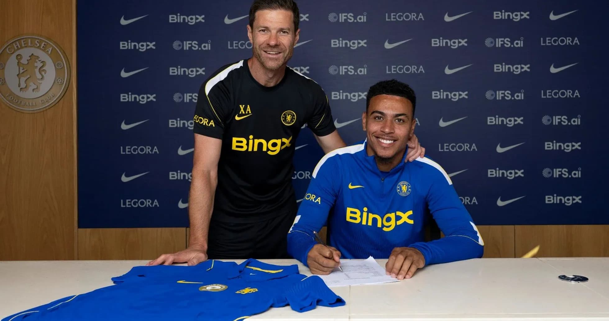 Player signing contract with coach at Chelsea FC