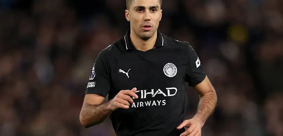 Player running during a football match in black kit