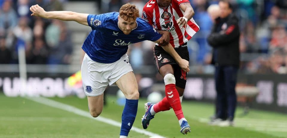 Everton player tackling Sunderland opponent during match